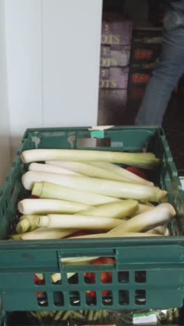 Vertical-Video-Showing-Interior-Of-UK-Food-Bank-Building-With-Fresh-Food-Being-Sorted-For-Delivery-1